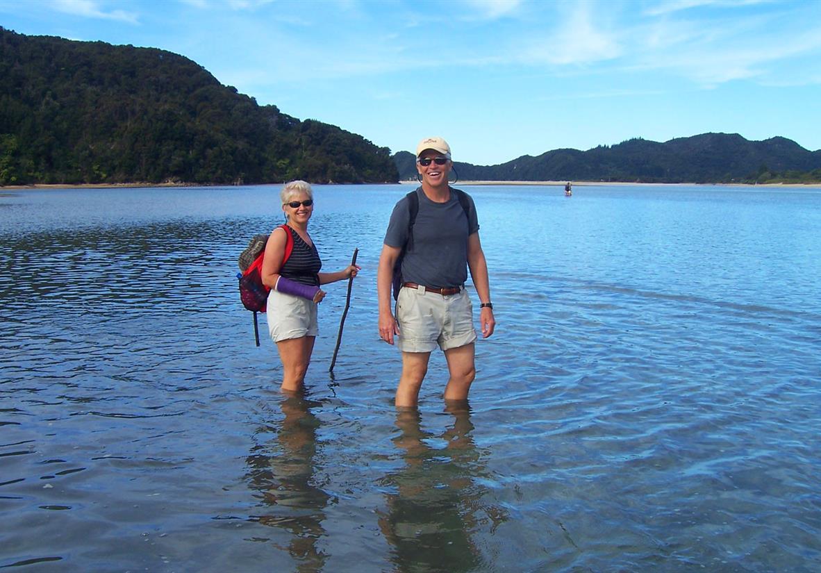 Wading across Awaroa Inlet