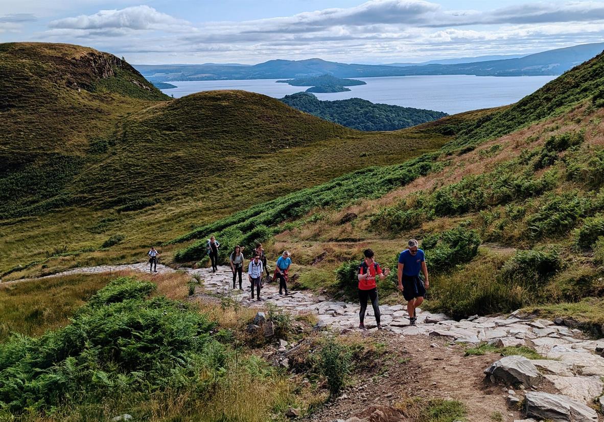 A group of walkers heading up Conic Hill